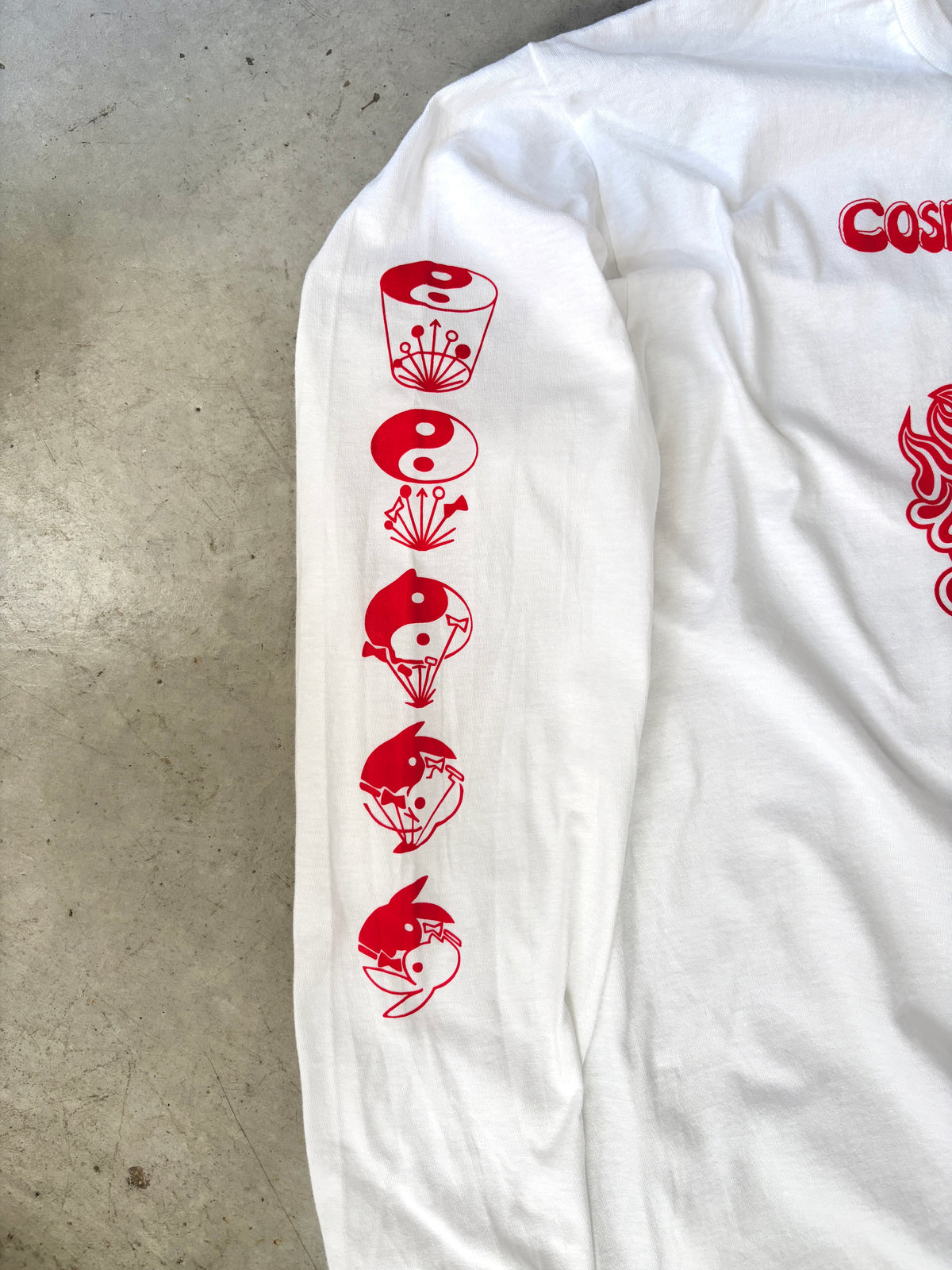 Close-up of a sleeve showing a red icon sequence of a cup, a yin-yang symbol, and three rabbit-head yin-yang designs