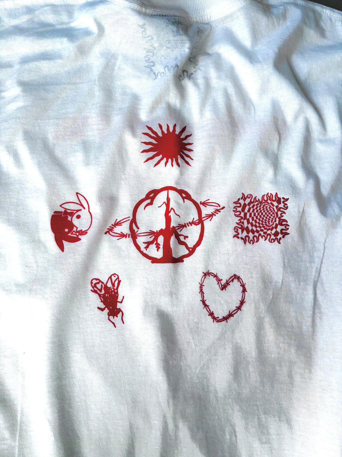 Close-up of the back print: red sun, rabbit, barbed-wire peace sign, checkered flame square, beetle and barbed-wire heart