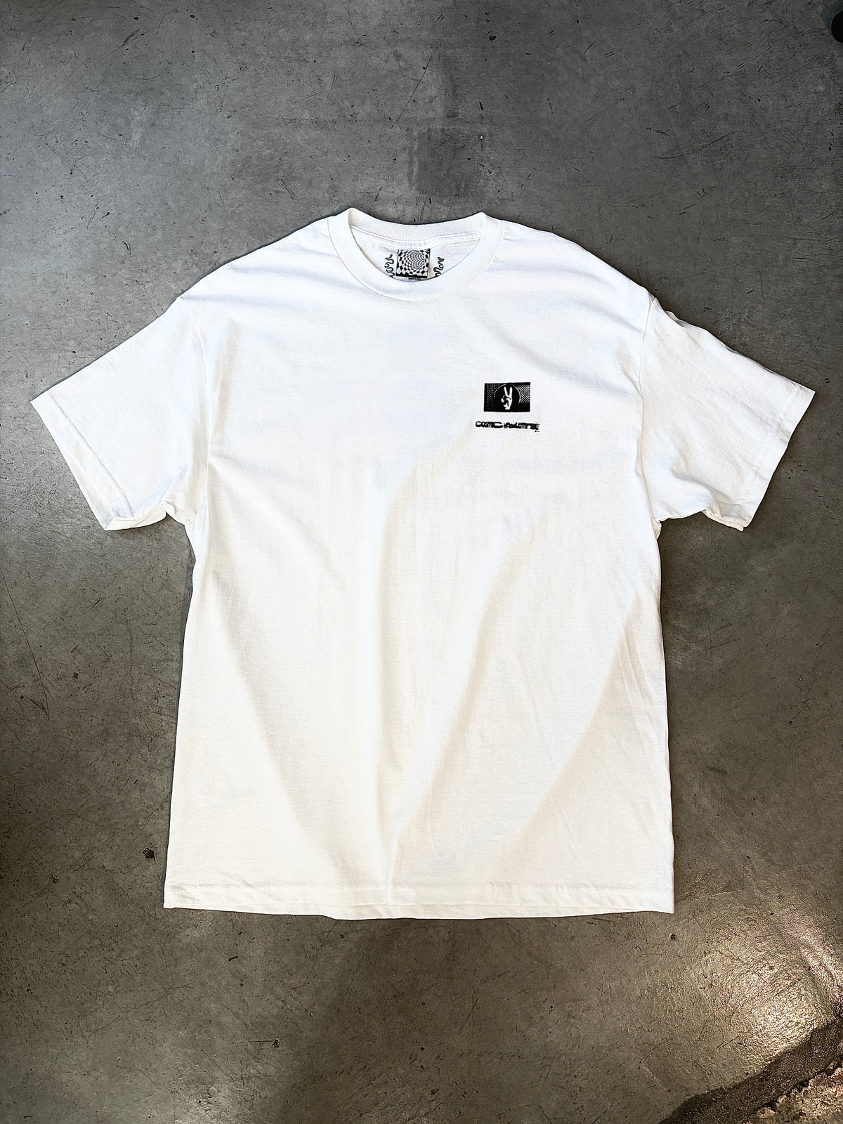 White short sleeve t-shirt with a small black graphic and text on the left chest, laid flat on a concrete surface.