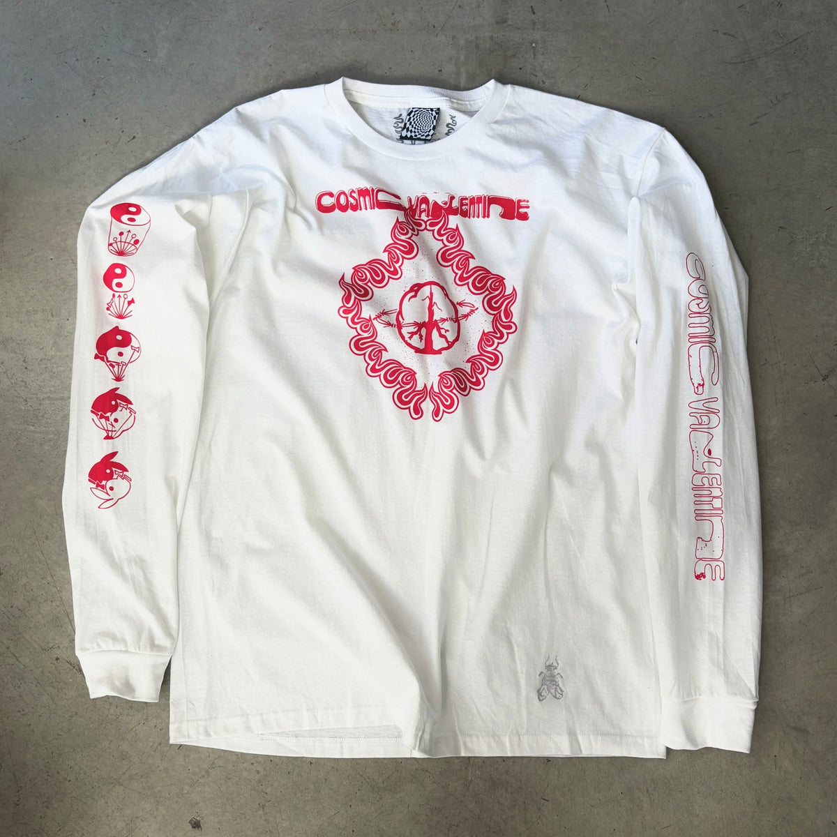 White Orbits long sleeve tee laid flat, red Cosmic Valentine wordmark and peace-sign flame graphic, red text on both sleeves