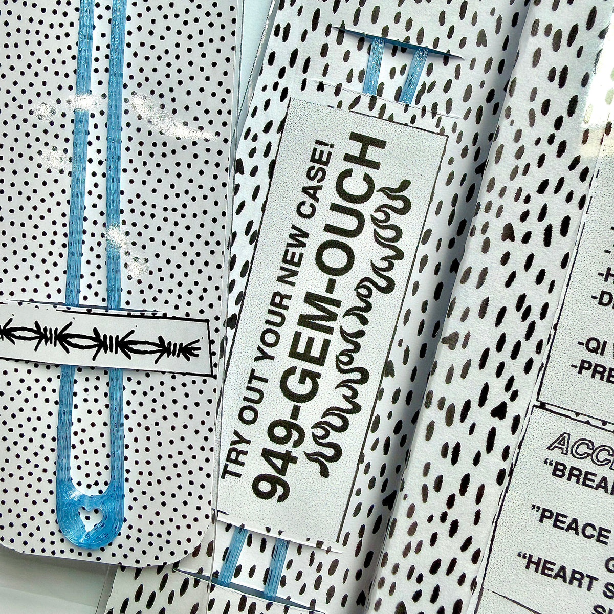 Close-up of the dotted packaging insert card and blue wrist tether that come with the Snap Case