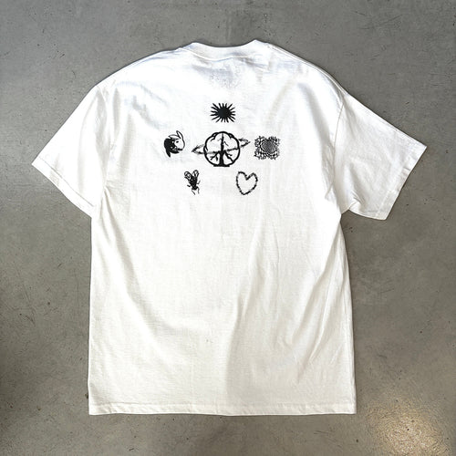 White short-sleeve t-shirt with black graphic designs, including a sun, heart, and abstract shapes, on the back.