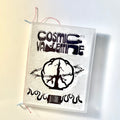 Cosmic Valentine Issue 1 zine with a clear textured cover, black wordmark and peace-sign art, and red thread binding